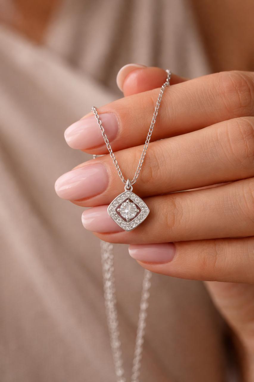 Close-up of silver square crystal pendant necklace with stone detailing