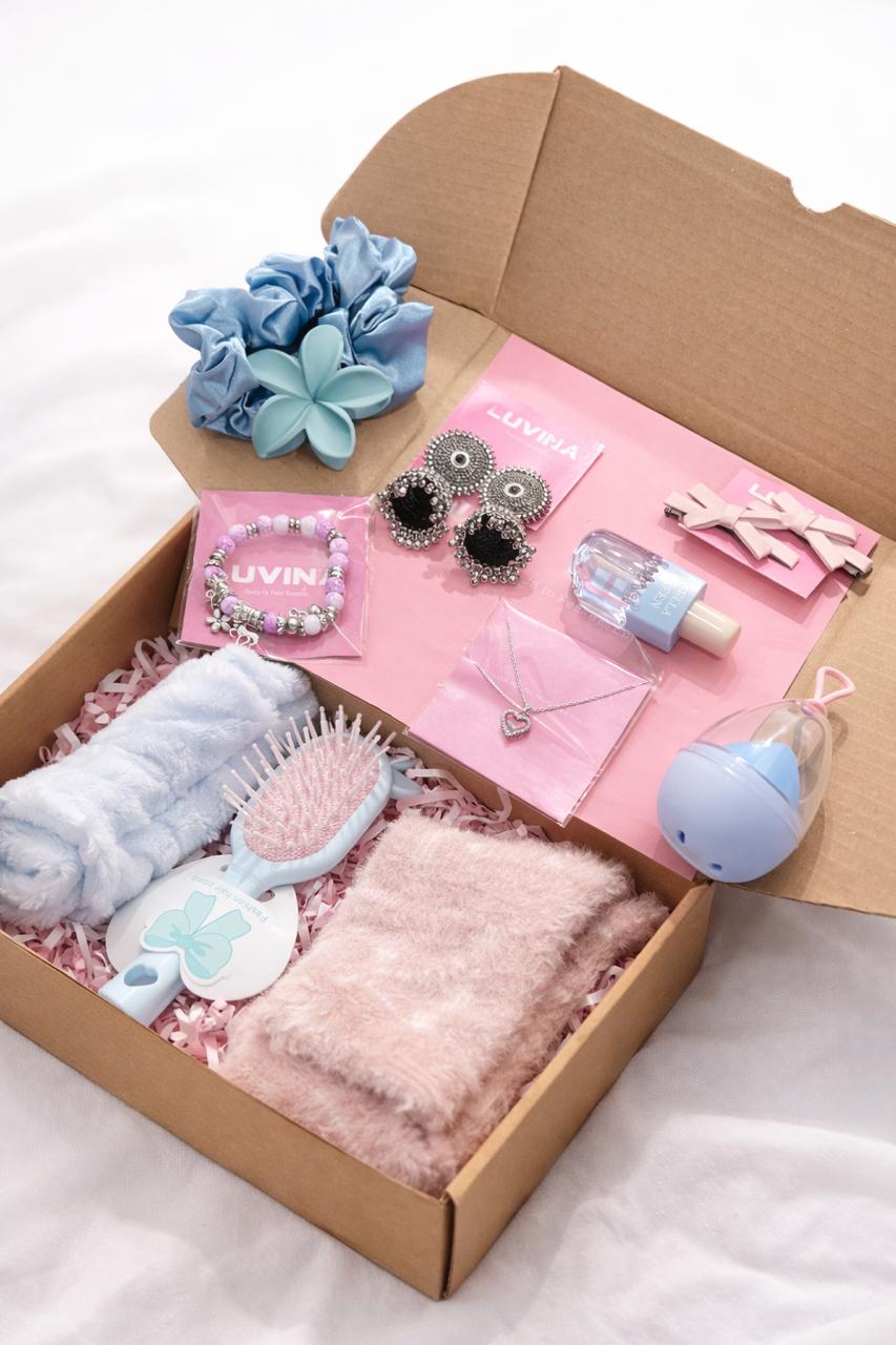 Collection of baby items in a box on a white background