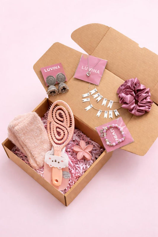 Cute gift combo for girls with jewellery, bracelet, socks, scrunchie and comb on pink background