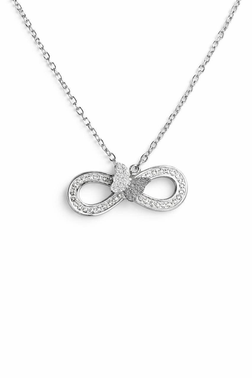Close-up of silver infinity butterfly pendant necklace with crystals