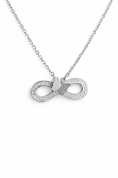 Close-up of silver infinity butterfly pendant necklace with crystals