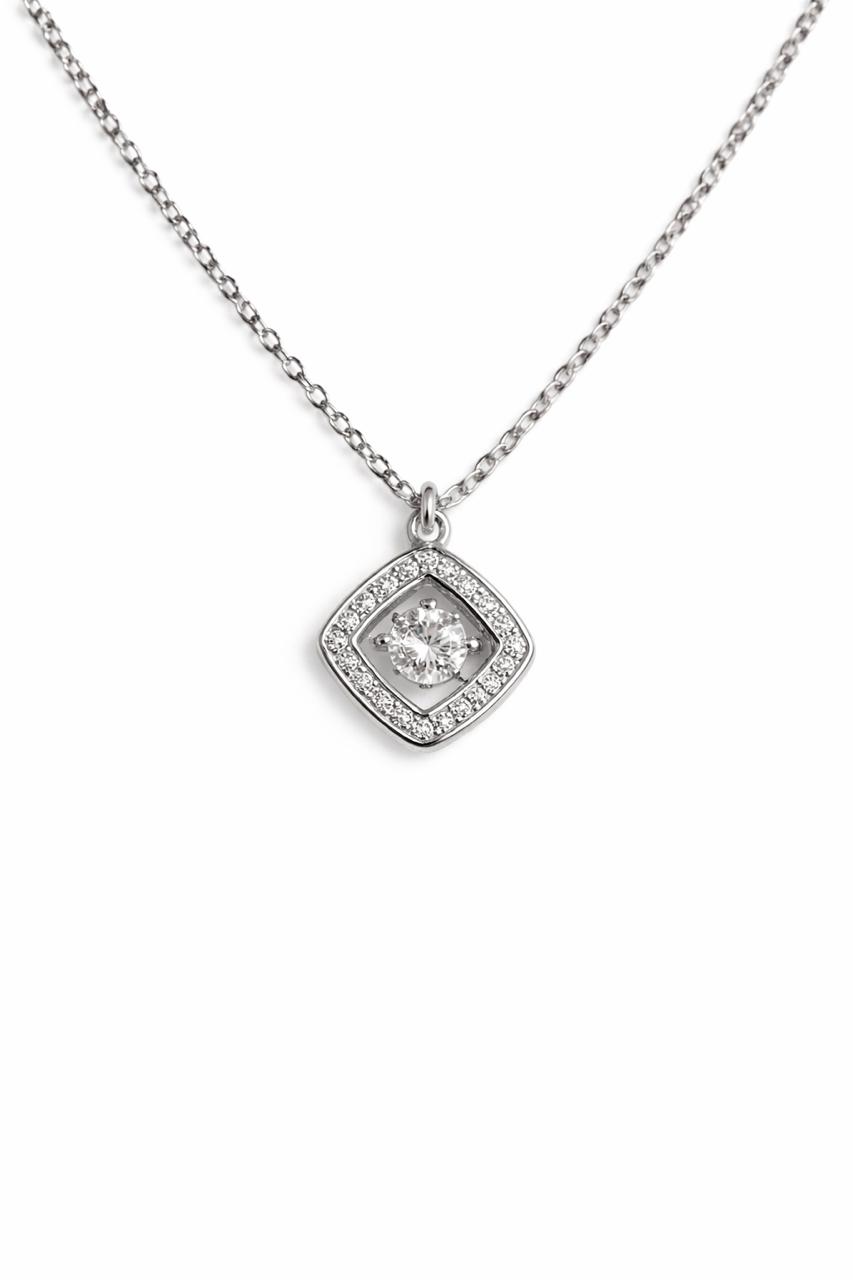 Close-up of silver square crystal pendant necklace with stone detailing